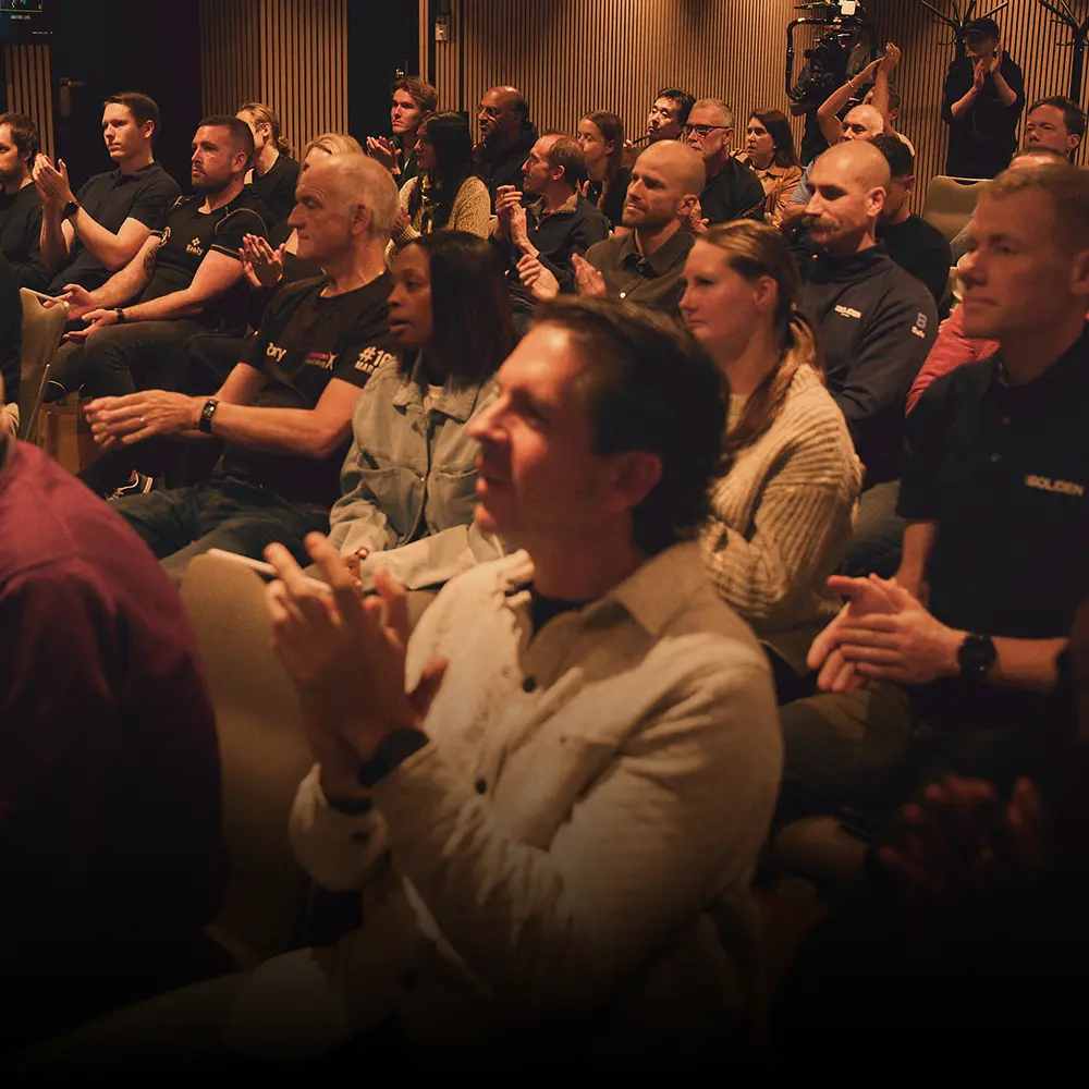 An engaged audience applauding at a BecomingX event.