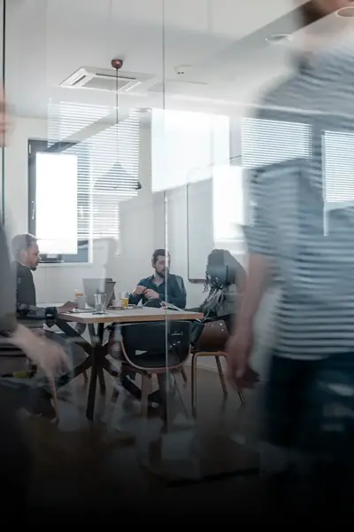 Company staff walking past a meeting room