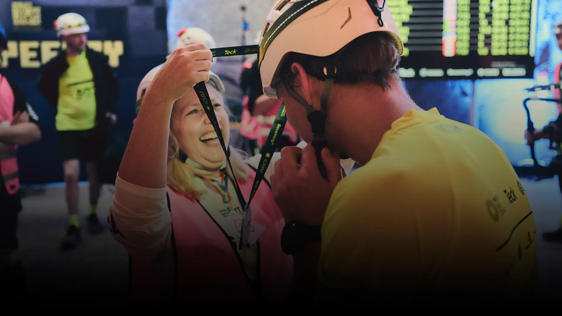 A World's Deepest Marathon participant receiving a medal from BecomingX COO Alexis Lambert.