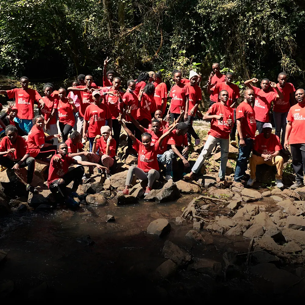 A group of students relaxing on a BecomingX Foundation project