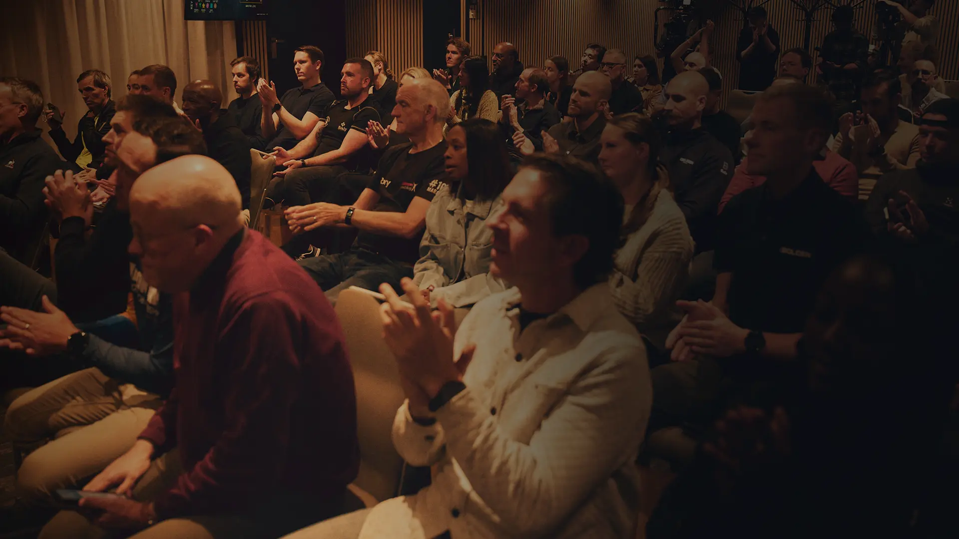 An engaged audience applauding at a BecomingX event.