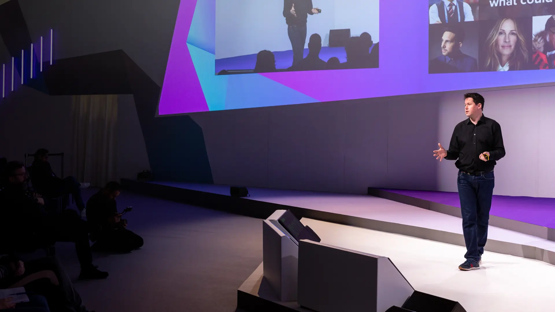 Paul Gurney, BecomingX CEO presenting on stage at an event.