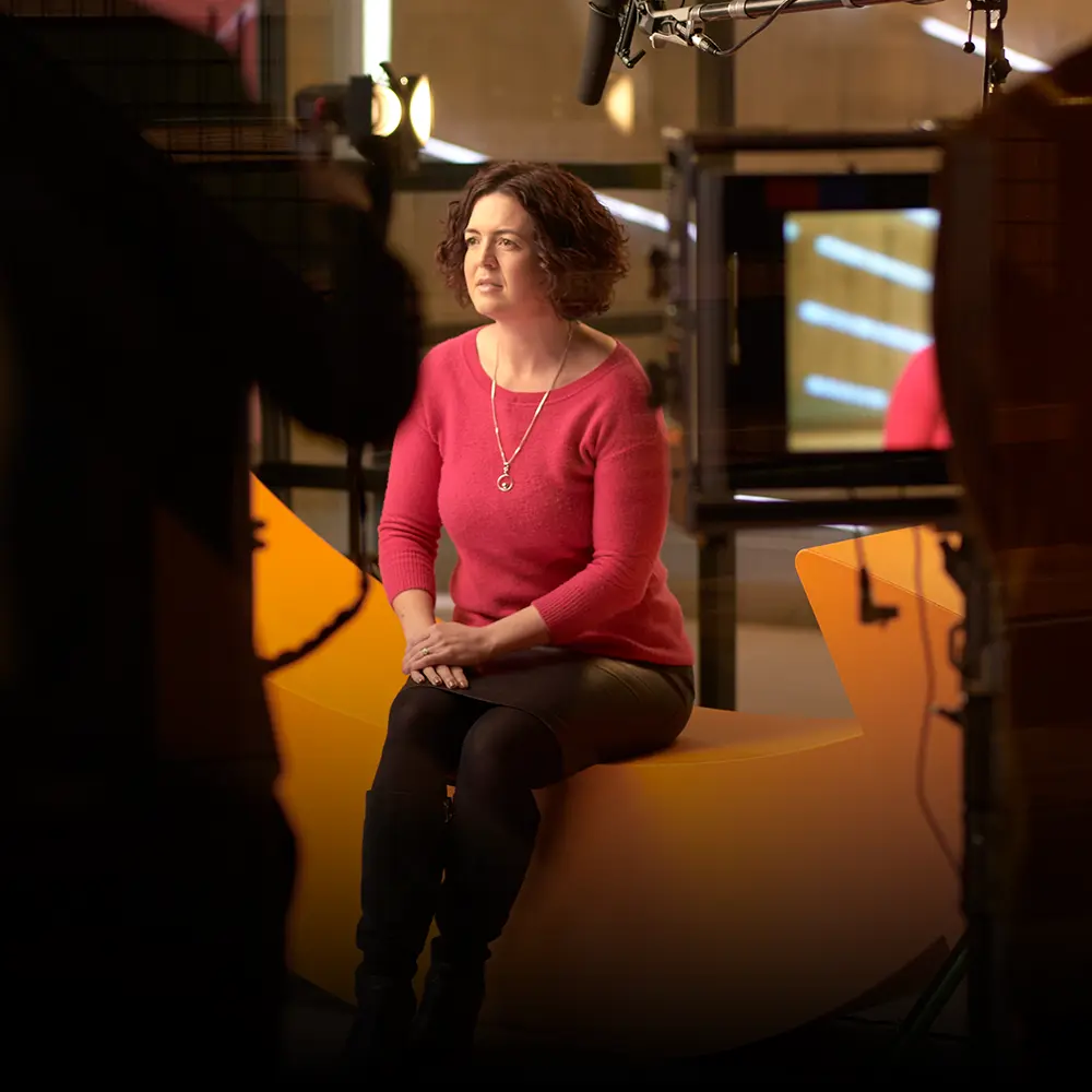 Beth Knight being filmed for Amazon on a professional video production set, surrounded by cameras and studio lighting.